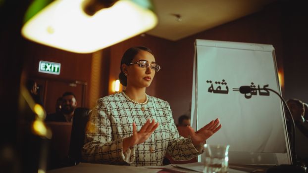 Middle Eastern woman speaking at a conference in Baghdad, Iraq.