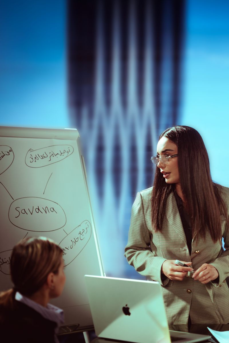 Professional woman giving a presentation in a Baghdad office with a cityscape view.