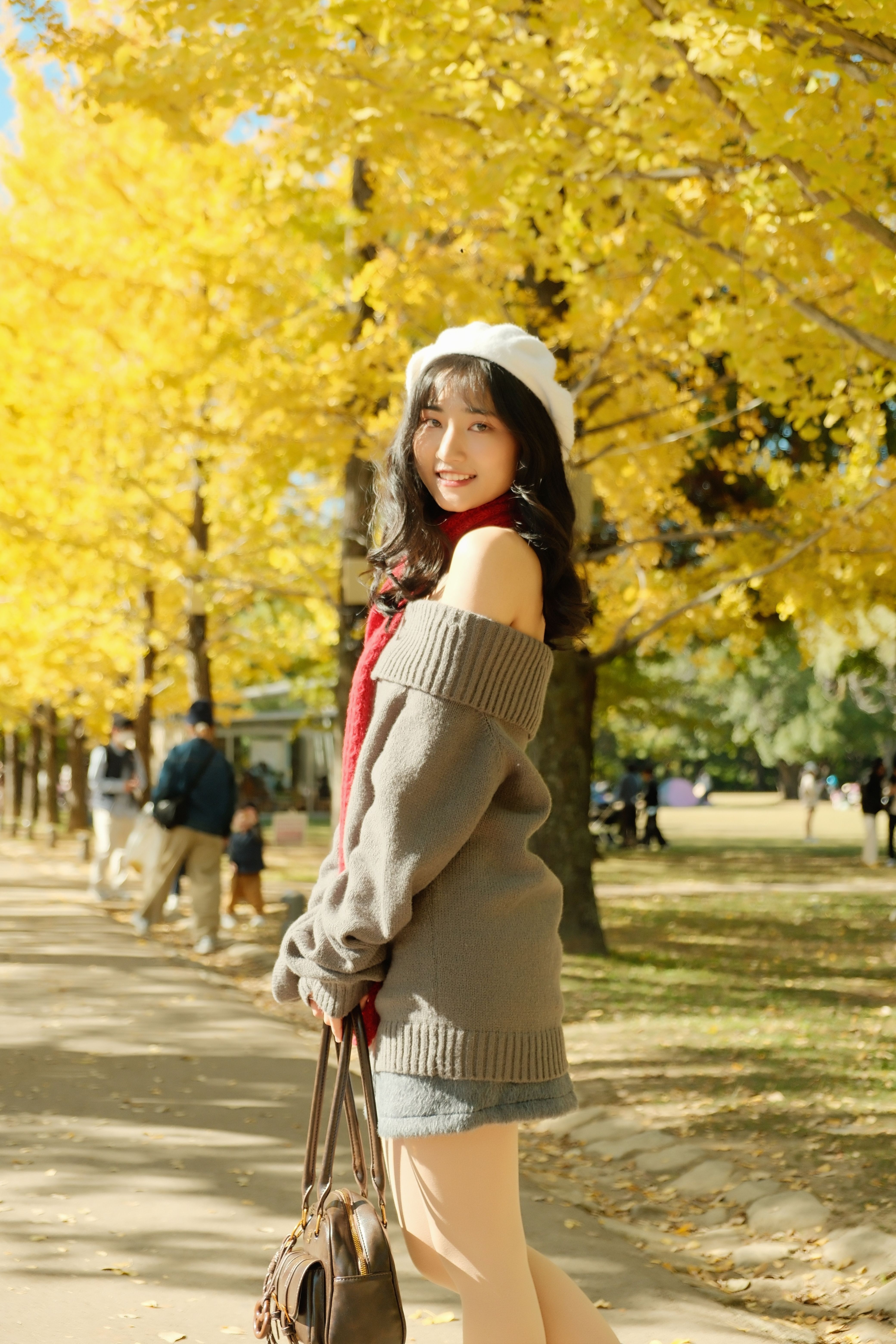 Young Woman Walking in Ginkgo Tree Park in Autumn · Free Stock Photo