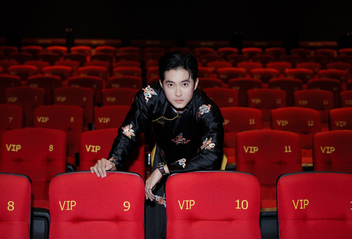 Elegantly dressed man in a VIP theater seating area, representing a premium Hamilton Broadway experience