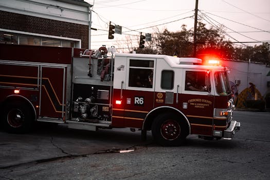Fire truck from Cherokee County Fire & Emergency Services on city street at twilight.