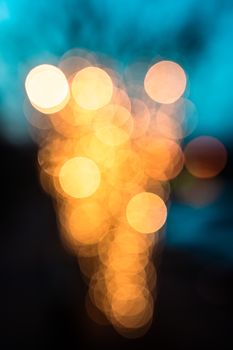 Colorful bokeh lights creating an abstract blurred background in warm hues.