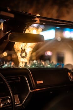 Artistic view inside a vintage car with bokeh lights, evoking nostalgia and warmth.