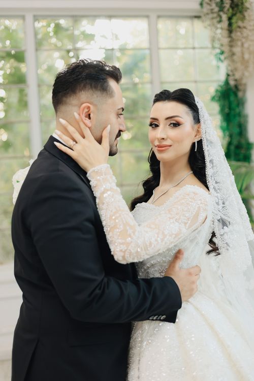 Free A beautiful bride and groom embrace indoors, celebrating their wedding in Şanlıurfa, Türkiye. Stock Photo