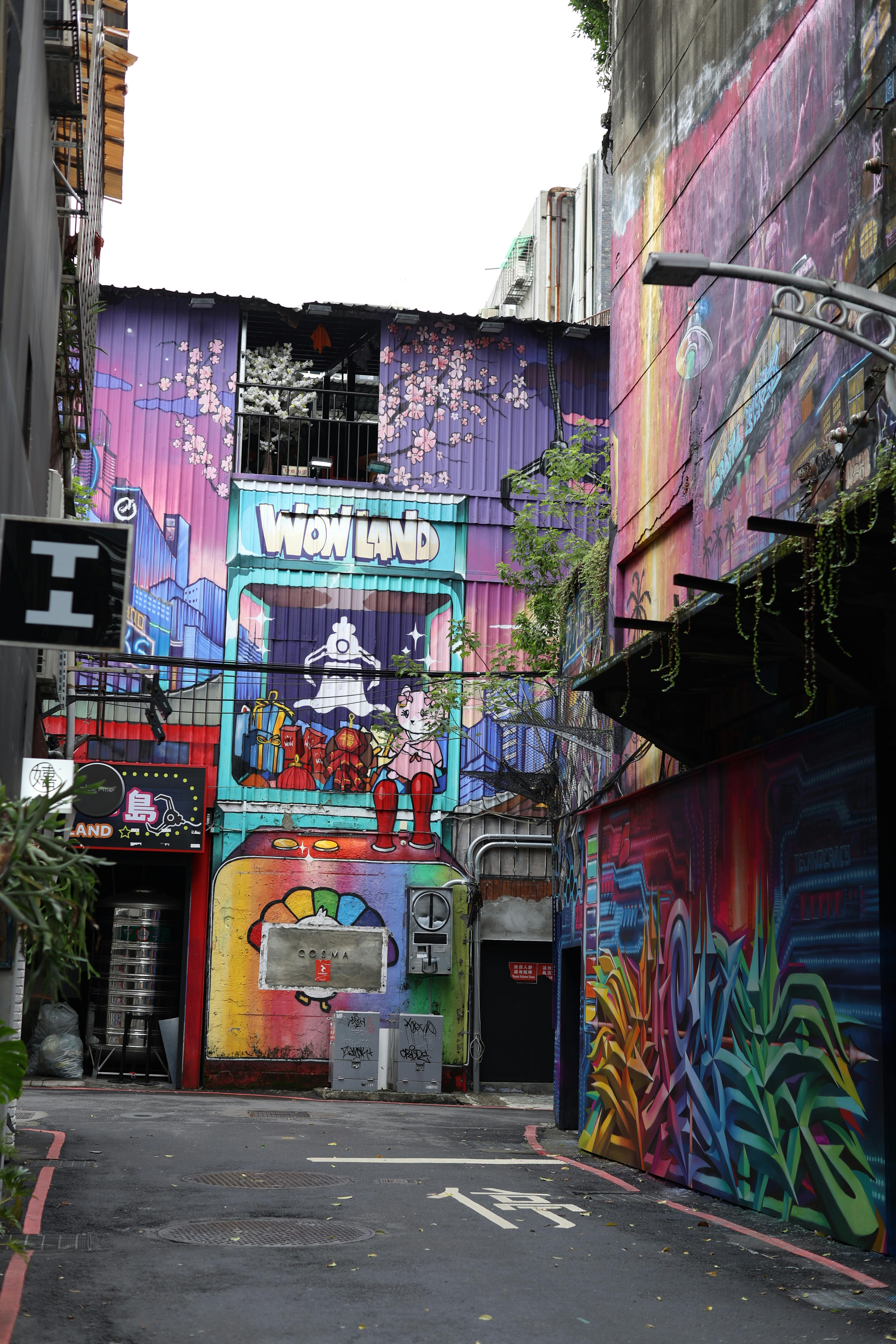 Free Colorful graffiti and street art in a narrow alleyway in Taipei City, Taiwan, showcasing vivid urban creativity. Stock Photo