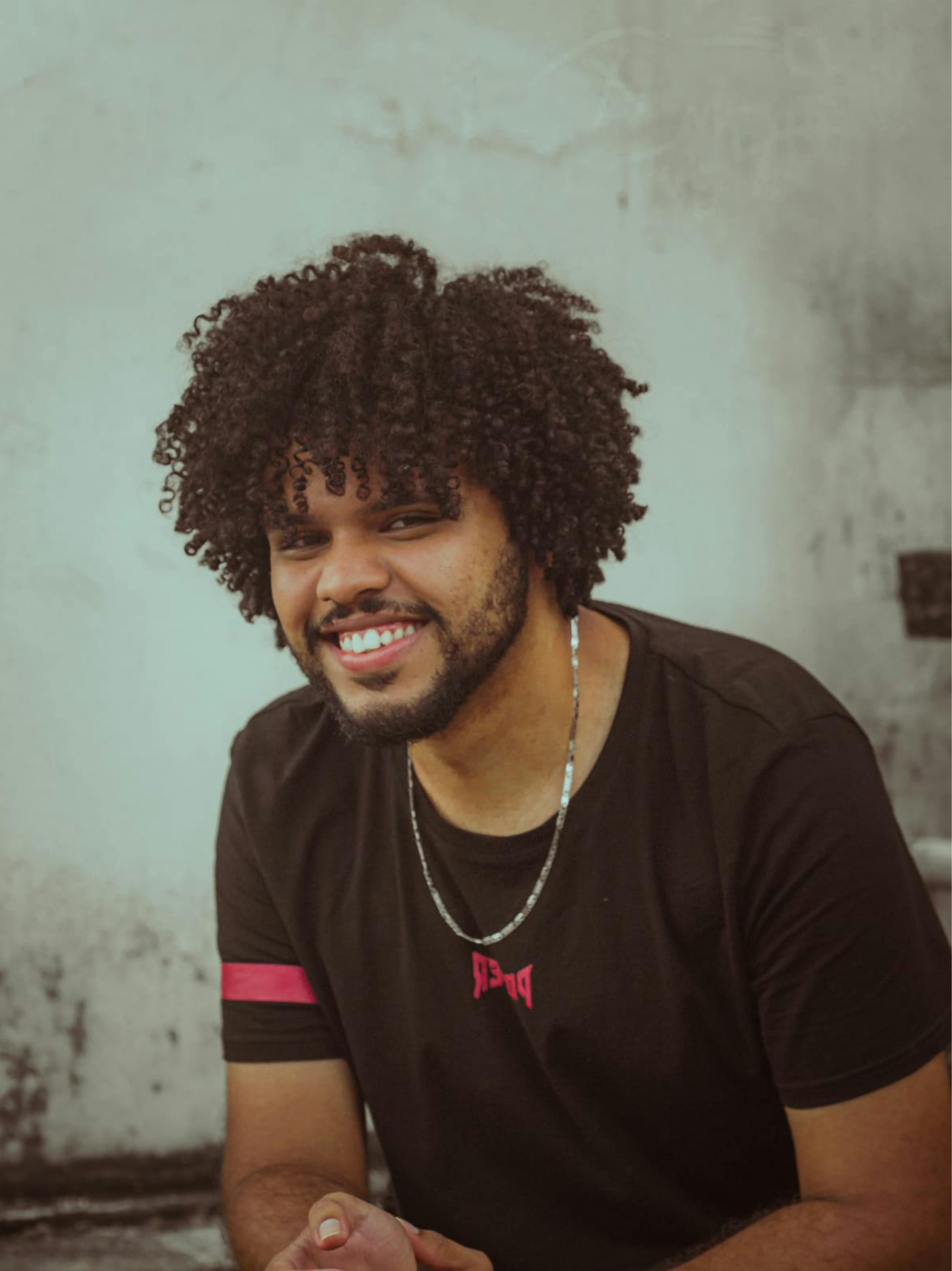 Portrait of a smiling man with curly hair in Recife, Brazil. Captivating and candid shot.