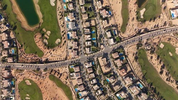 Discover the luxury homes and green golf courses in Sheikh Zayed, Egypt, captured from above.