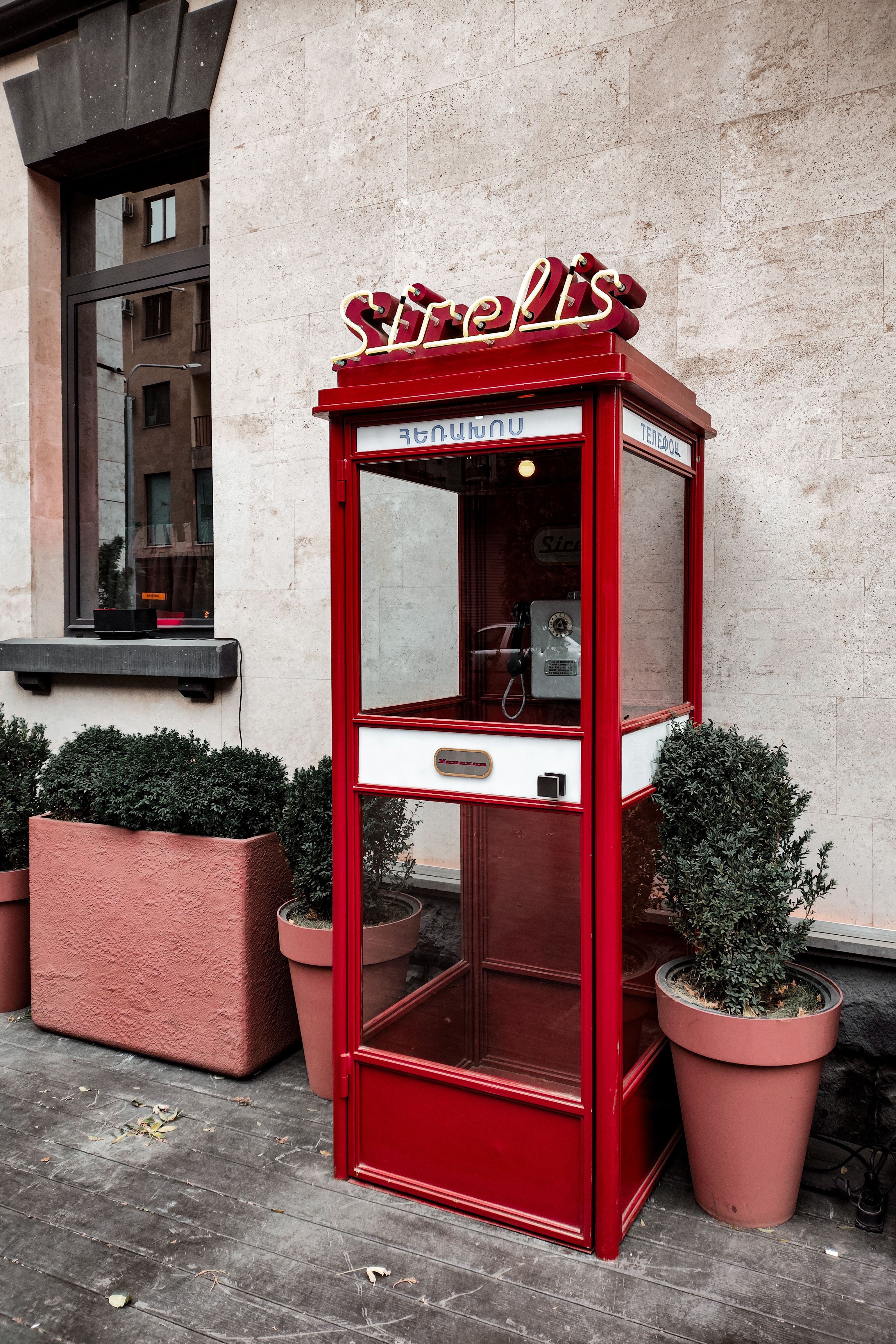 Garbage Can in front of a Red ATM · Free Stock Photo