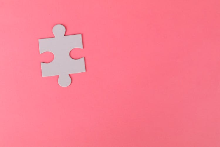 Jigsaw Puzzle On Pink Background