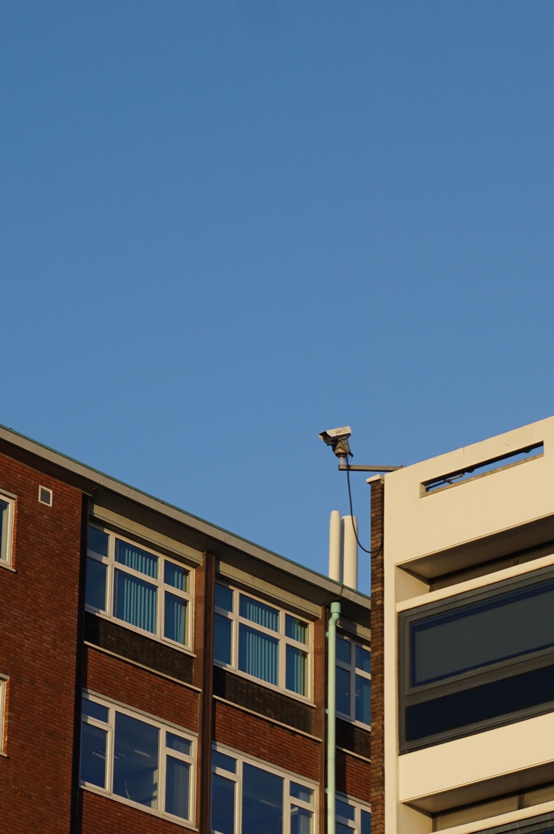 Modern Architecture Against Clear Blue Sky · Free Stock Photo