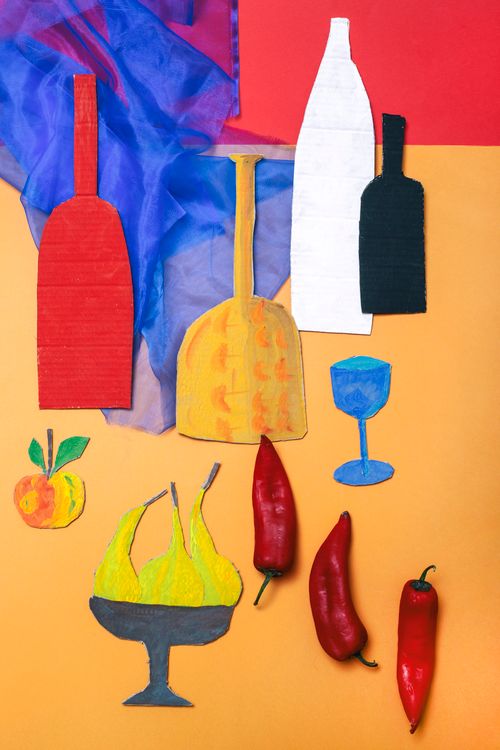 Free Artistic still life featuring colorful cutout bottles, fruits, and peppers on a vibrant background. Stock Photo