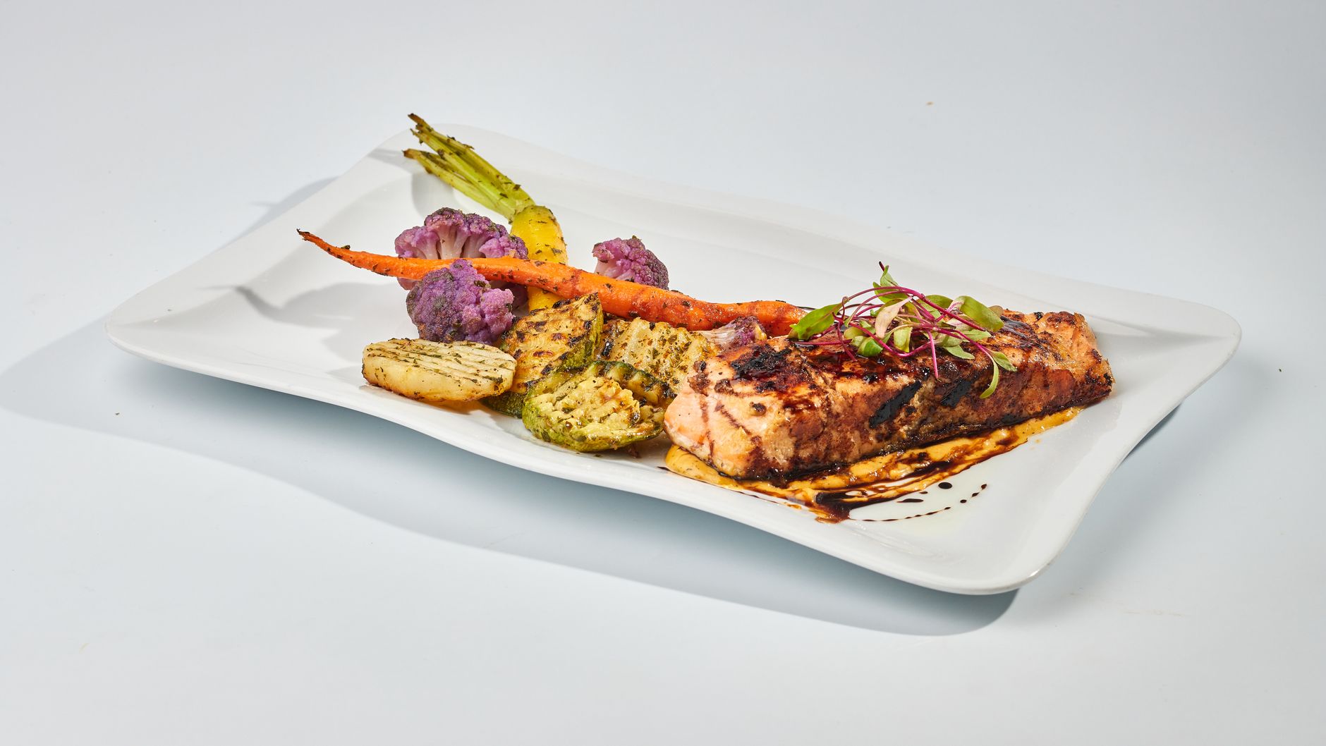 A beautifully plated dish of roasted rabbit, garnished with herbs, ready to be served