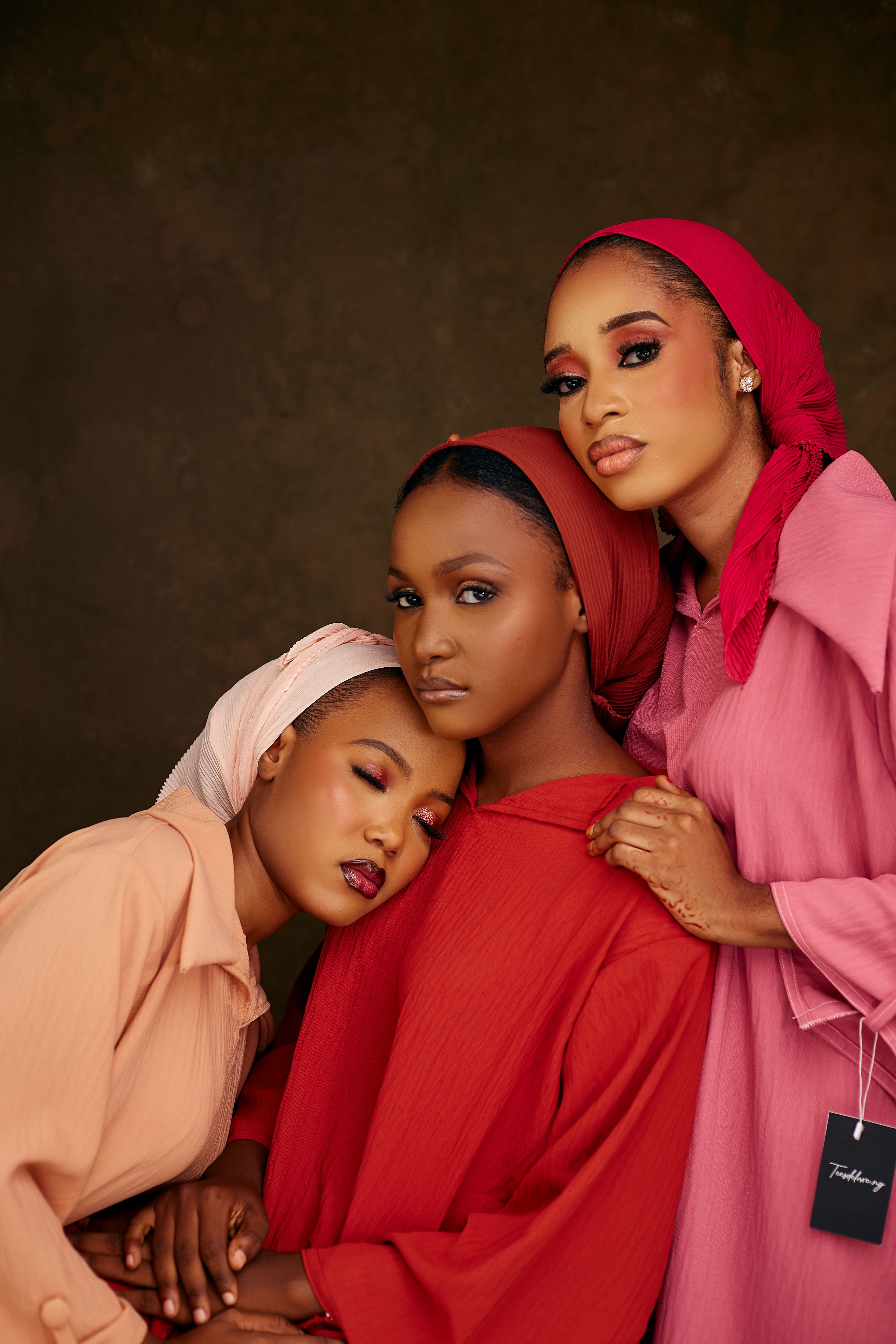 Striking portrait of three women wearing vibrant hijabs and dresses. Fashion and beauty.