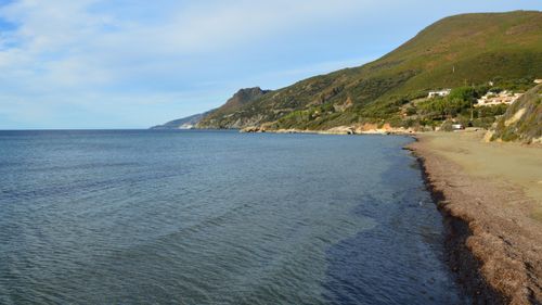 Free Peaceful coastal landscape featuring Farinole beach, Corse, France with calm sea and lush hills. Stock Photo