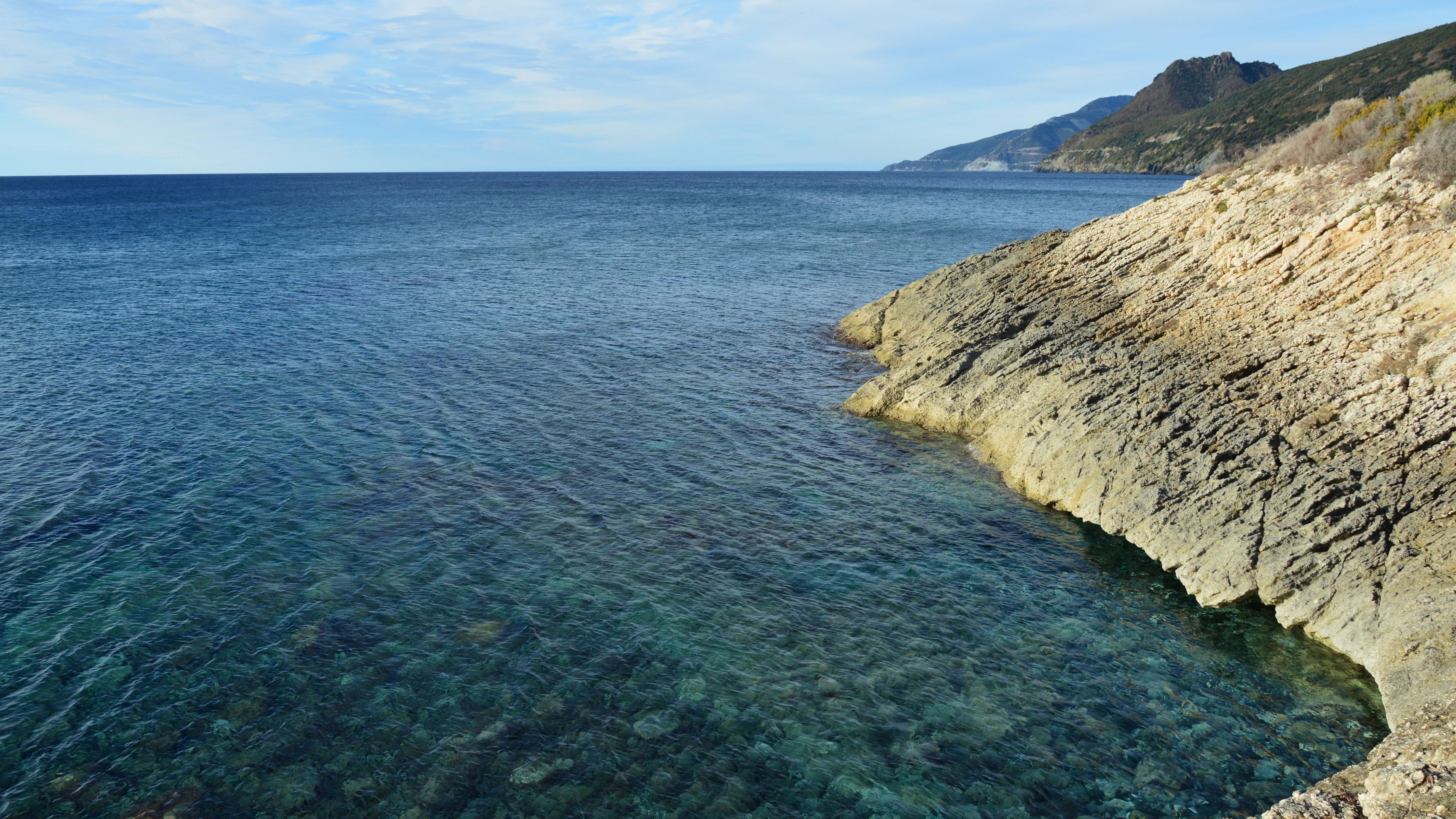People enjoying a warm summer day on a beach in Sarandë, Albania
