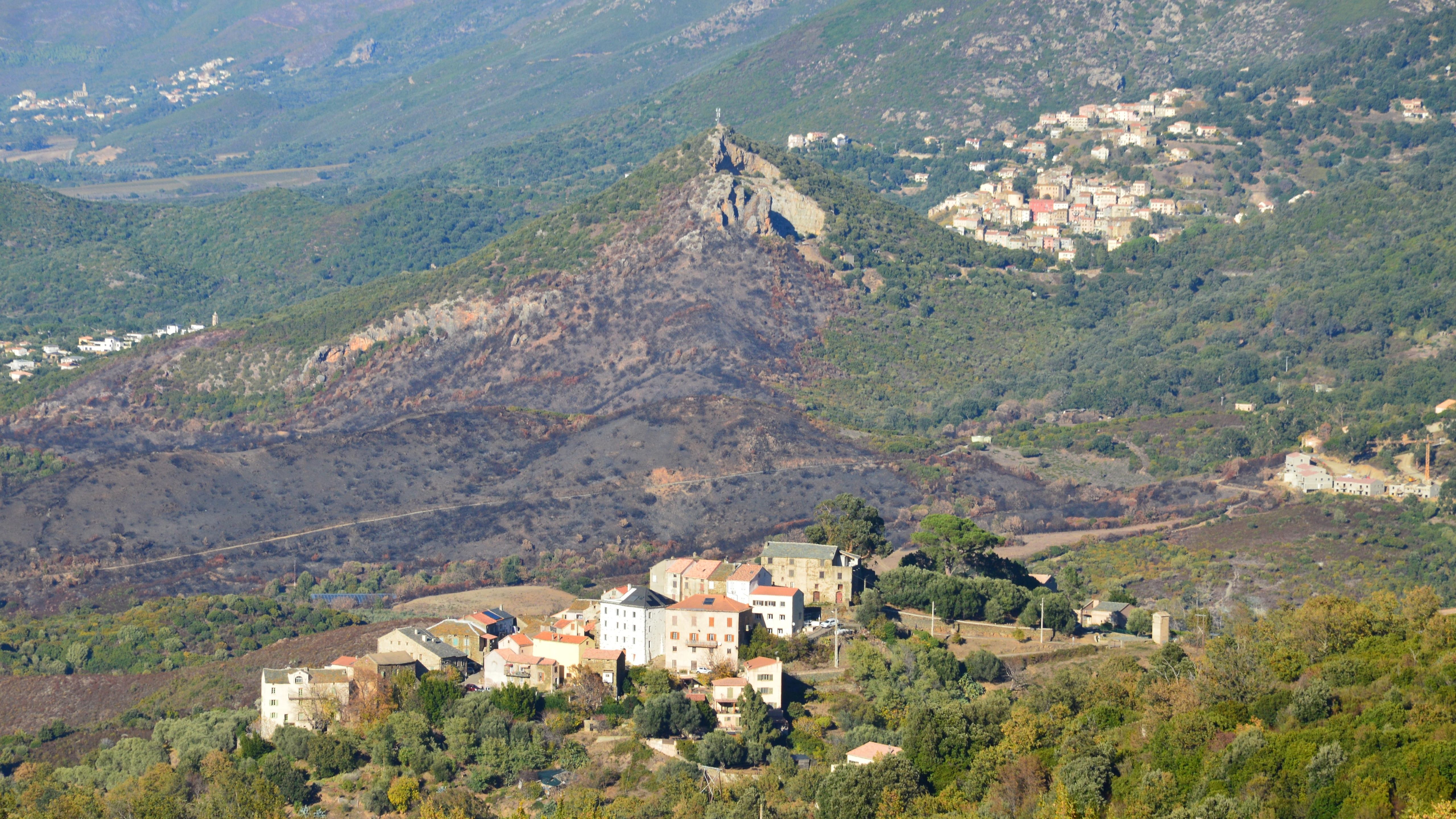 Aerial landscape of Murato village and surrounding hills in Corsica, France.