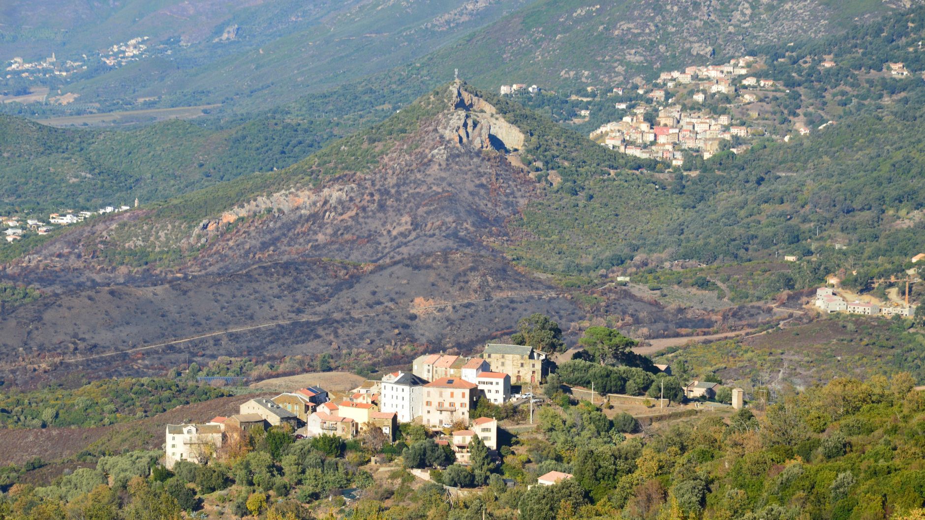 Aerial landscape of Murato village and surrounding hills in Corsica, France.