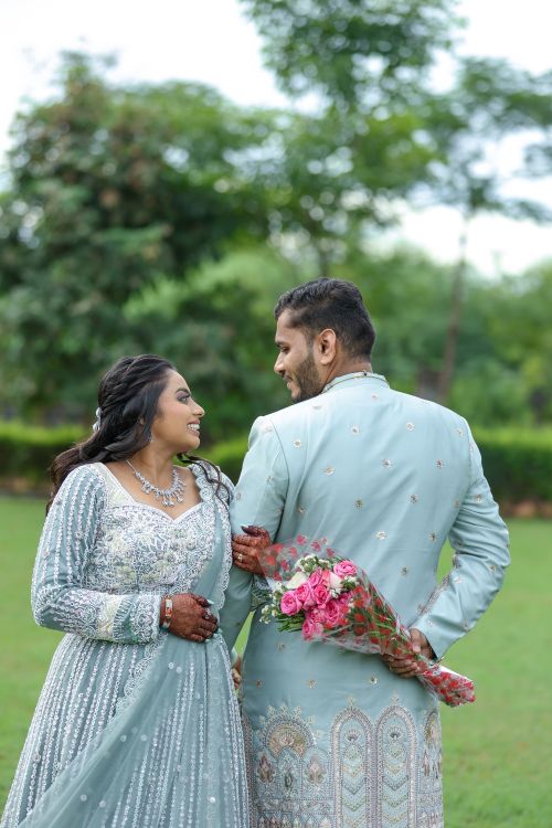 Free Happy couple in elegant attire enjoying a romantic moment outdoors. Stock Photo
