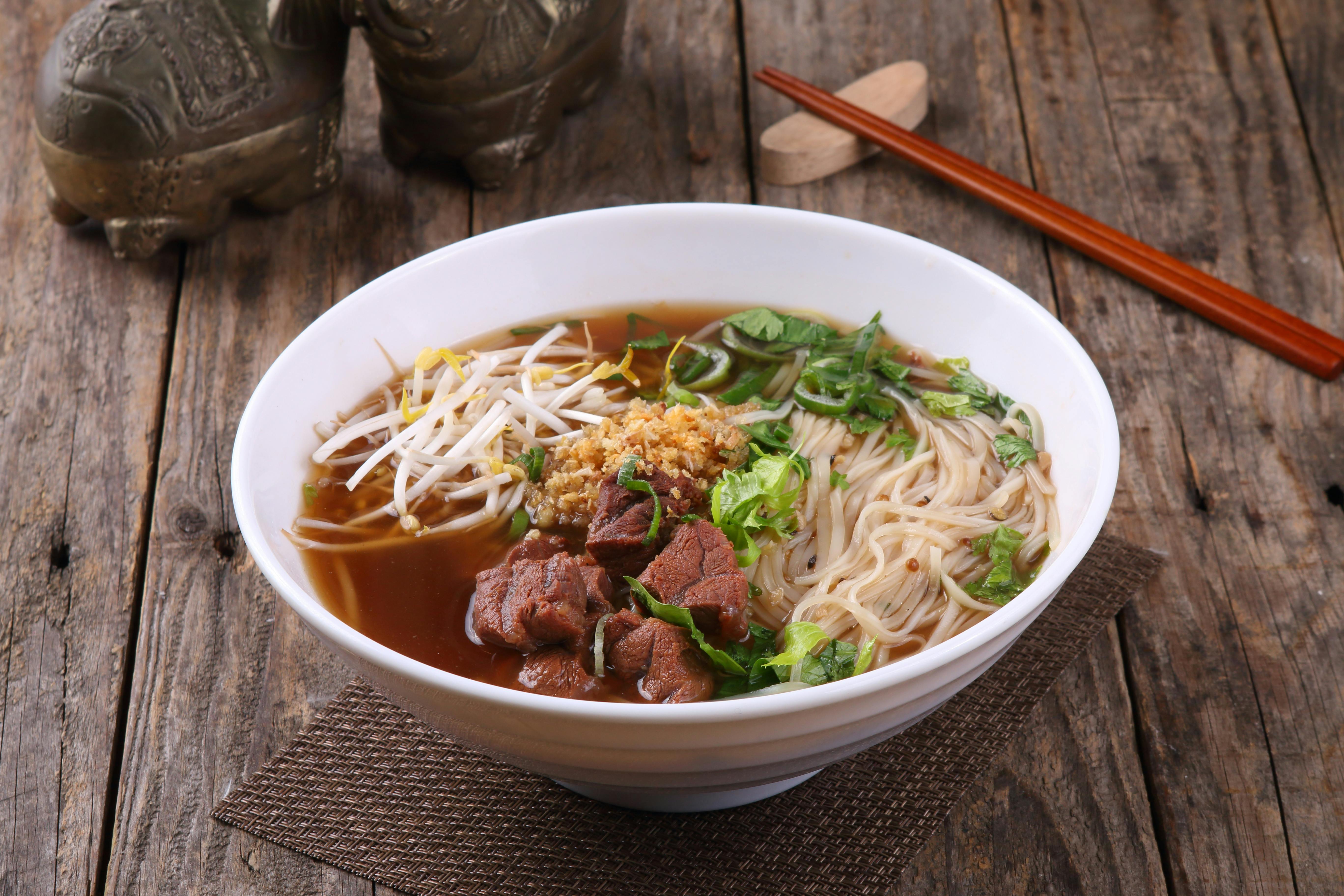 Savor this hearty bowl of Asian pho with beef, rice noodles, and fresh vegetables.