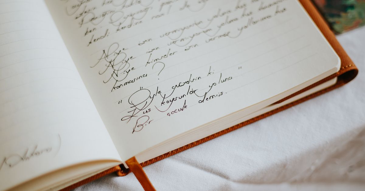 Notebook With Text Open Notebook with Handwritten Text on a Table · Free Stock Photo