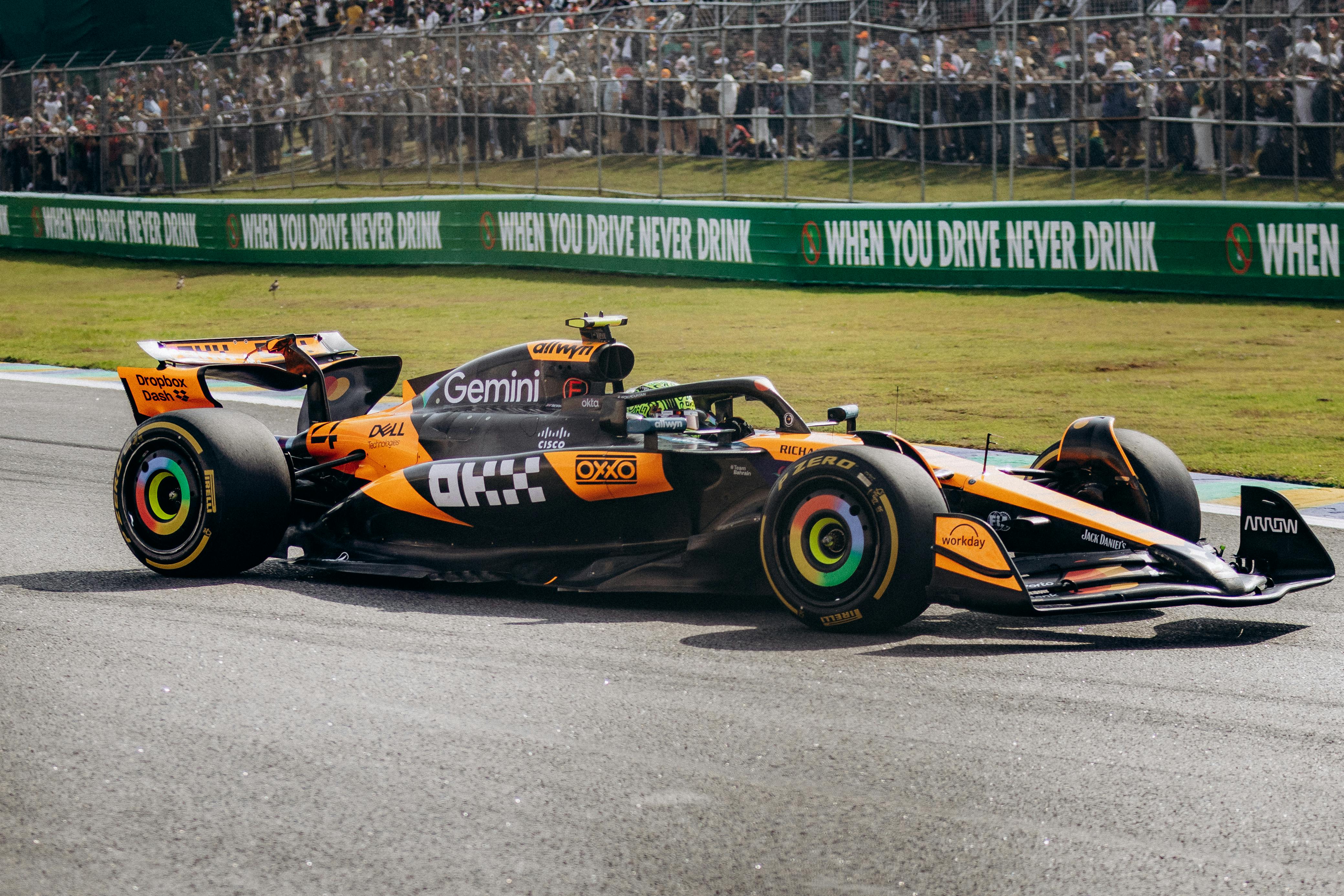 Dynamic image of a Formula 1 car racing at the S&atilde;o Paulo circuit, capturing the speed and excitement of motorsport.