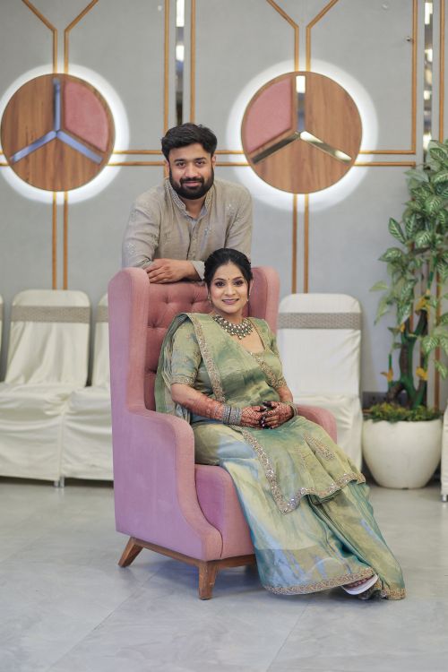 Free A stylish indoor maternity photoshoot with a couple in a modern setting featuring elegant outfits. Stock Photo
