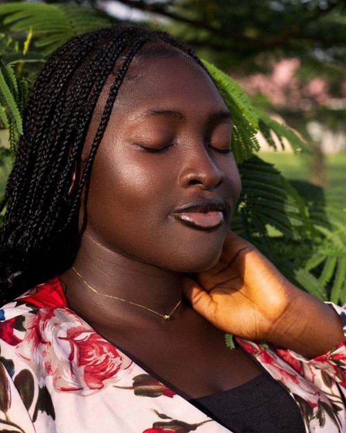 Free Serene portrait of a woman enjoying nature in Yola, Nigeria, under the warm sunlight. Stock Photo