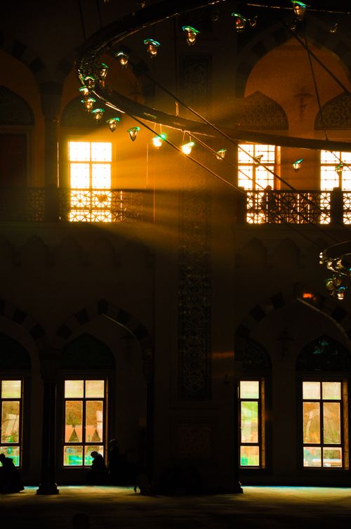 Free Sunlight filters through a serene mosque, creating a peaceful ambiance with warm tones. Stock Photo