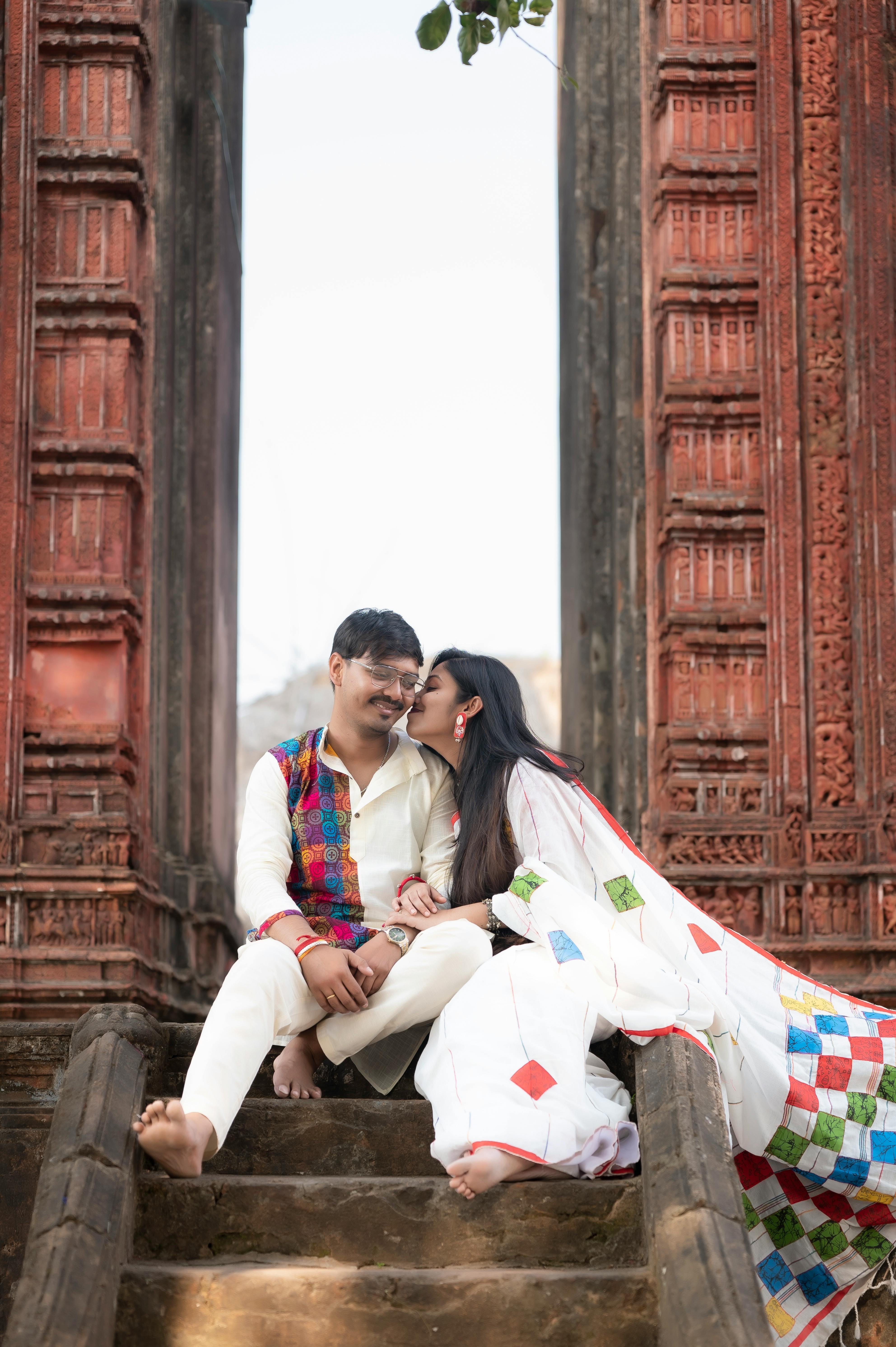 A couple embraces on the steps of an ancient temple in Ausgram, West Bengal, India.