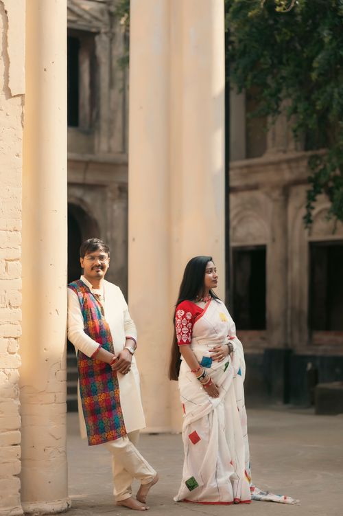 Free Couple in traditional Indian attire posing at historic site in Ausgram, West Bengal. Stock Photo