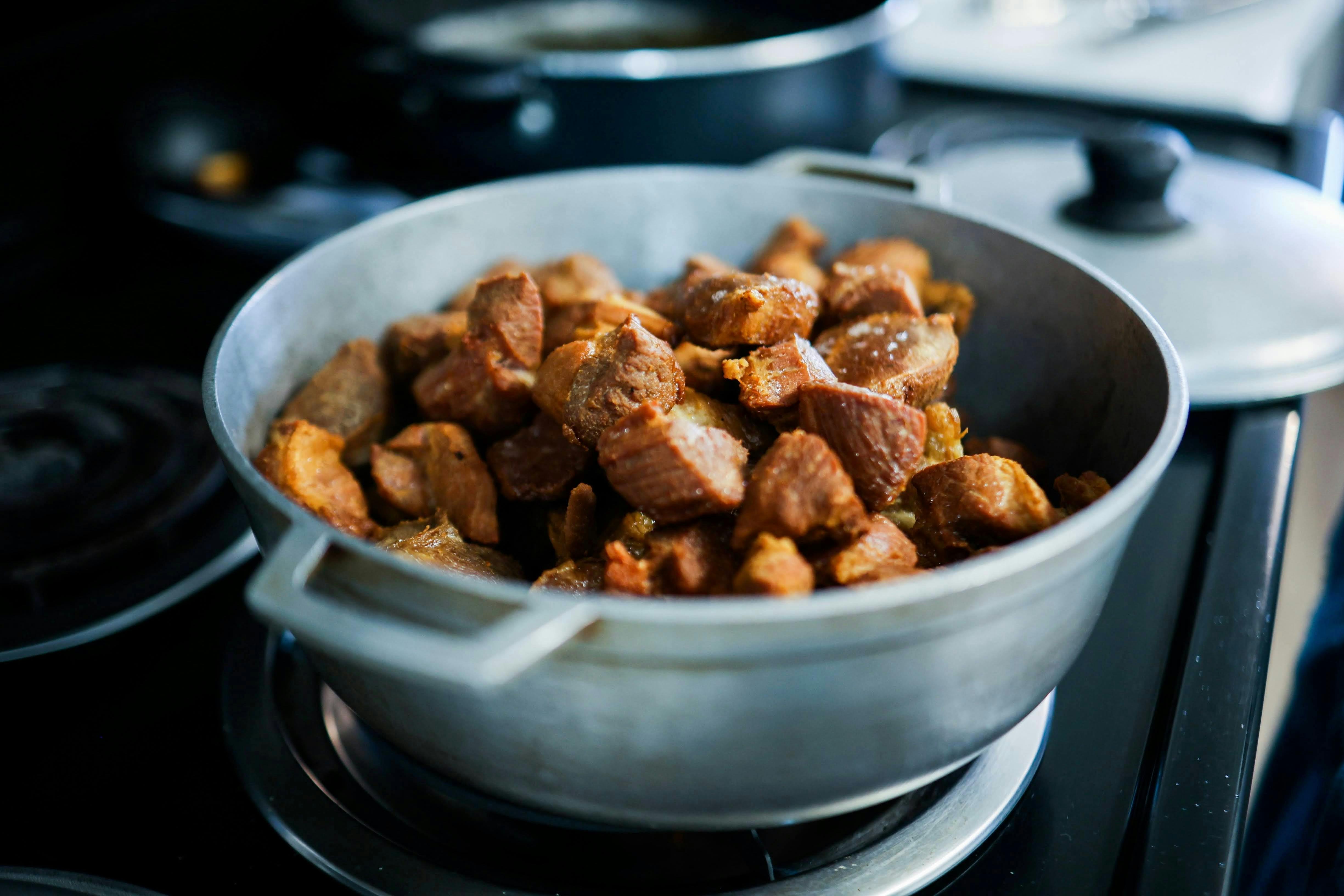 Hearty cooked meat pieces in a pot, perfect for home-cooked meals.