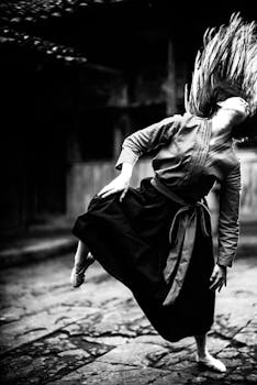 Captivating black and white image of a woman in graceful dance motion.