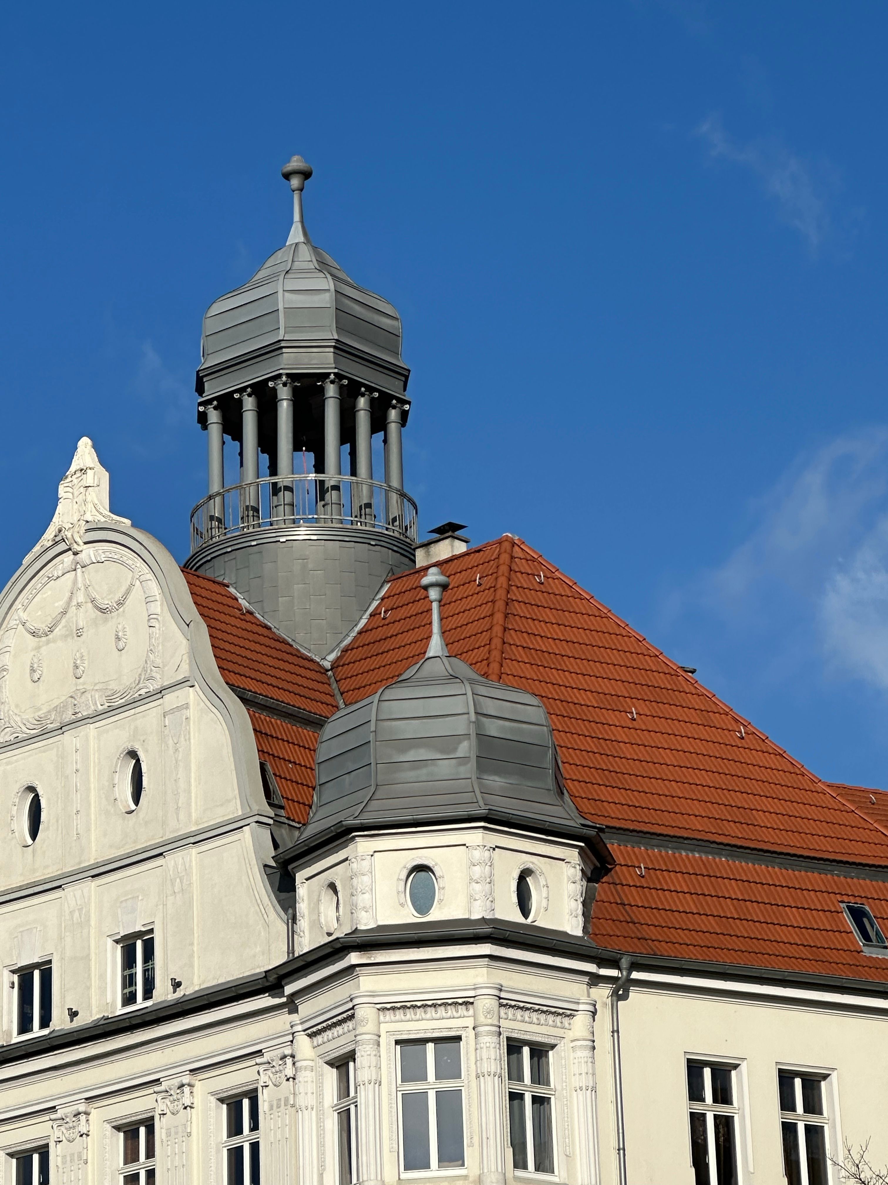 Historic European Building with Red Roof Under Blue Sky · Free Stock Photo
