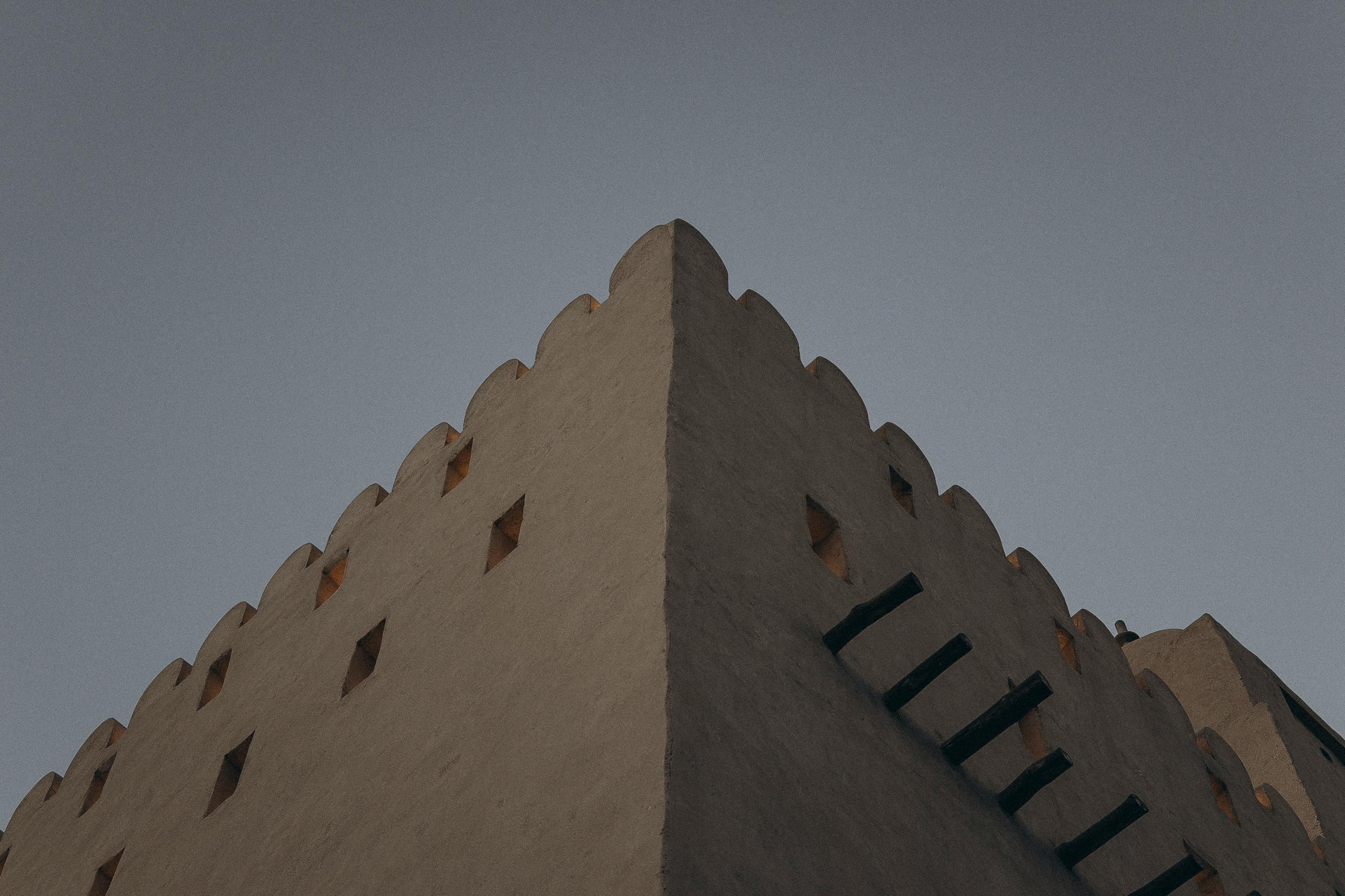 Free A traditional architectural structure in Abu Dhabi, United Arab Emirates, photographed at dusk. Stock Photo