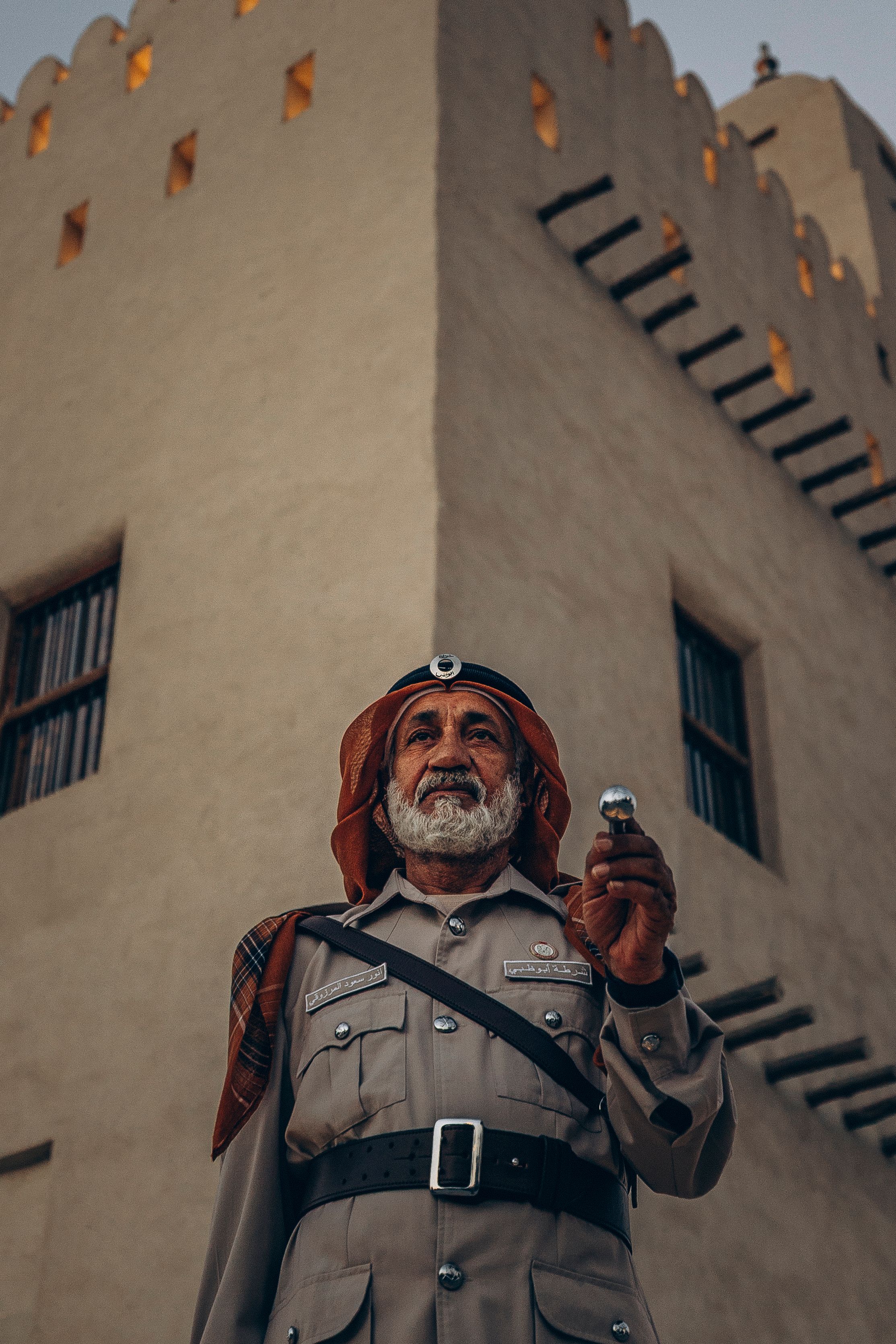 Traditional Emirati Guard by Historic Fort in Abu Dhabi · Free Stock Photo