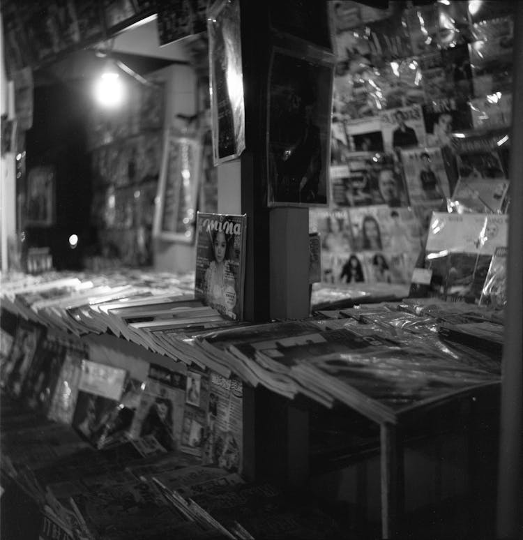 Black And White Photography Of A Kiosk With Magazines