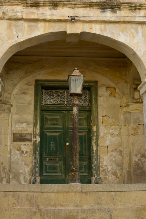 Free Rustic green door and vintage lantern of a historic villa in Malta, showcasing Mediterranean architecture. Stock Photo