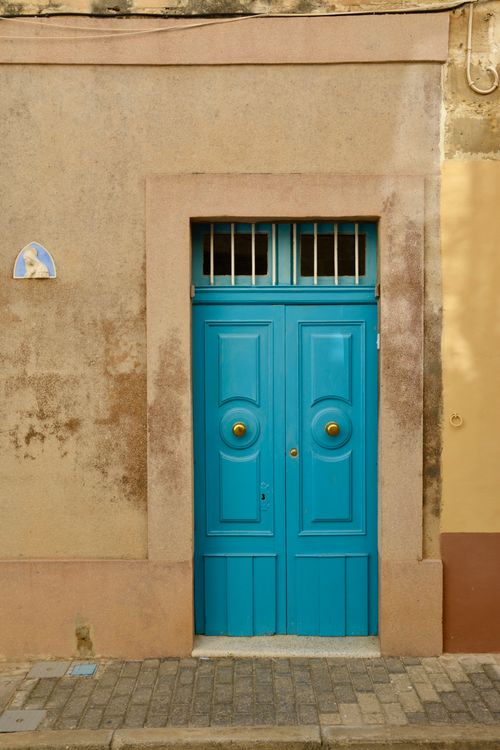 Free A vibrant blue door set in a rustic wall in Malta, showcasing Mediterranean architecture. Stock Photo