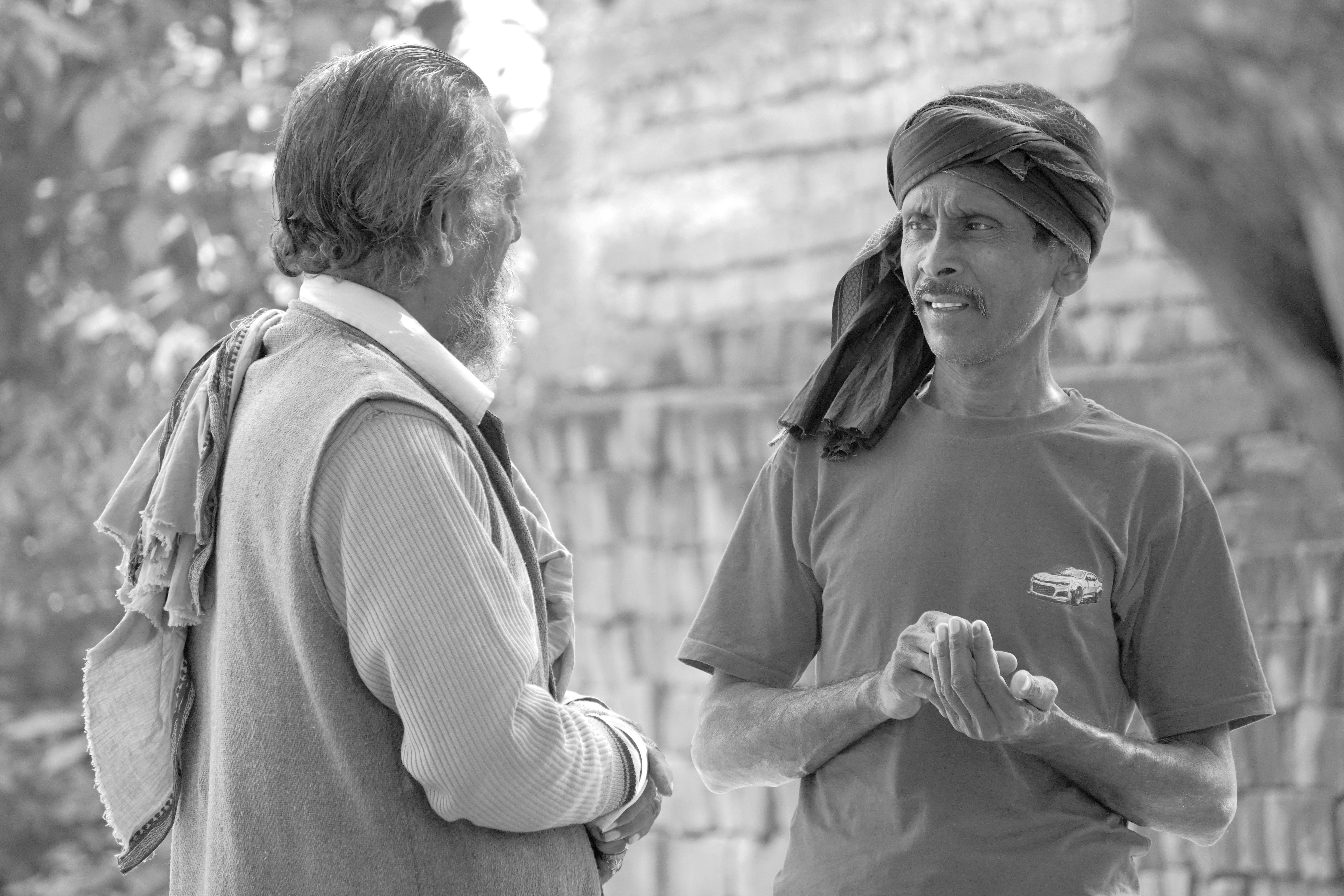 Two Men Conversing in a Rural Setting (Black and White)