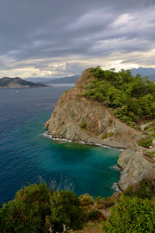 Free Breathtaking view of green cliffs and turquoise sea along the rocky coast of Fethiye, Turkey. Stock Photo