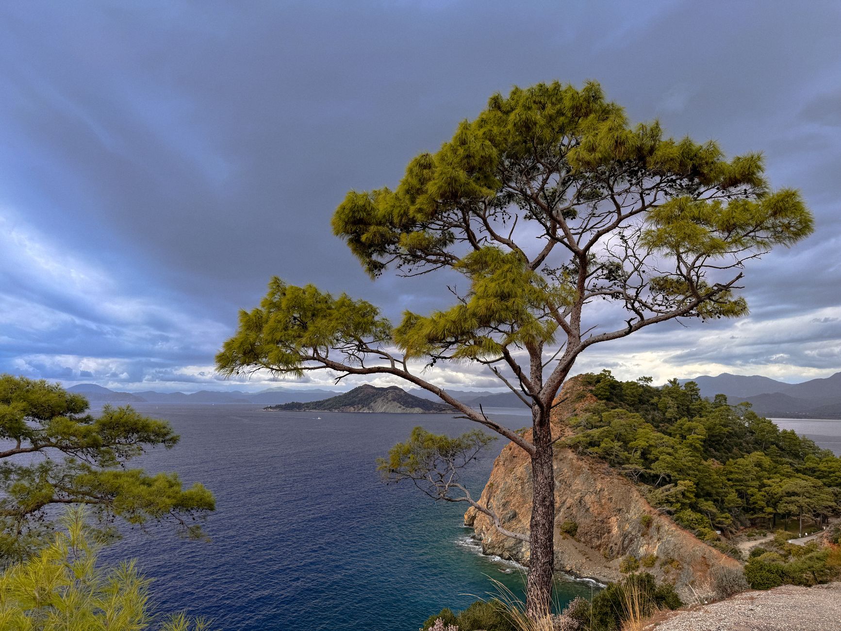 A breathtaking view of Fethiye's rocky coastline with lush cliffs and a turquoise sea.