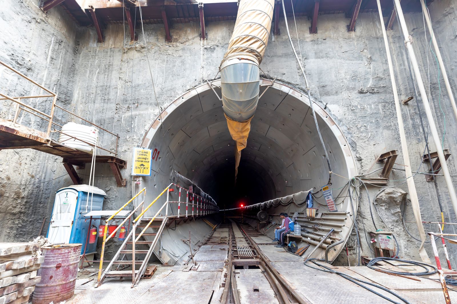 Tunnel entrance with machinery at an underground construction site