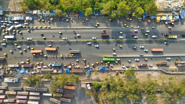Aerial view of a busy highway with vehicles and stalls, showcasing urban life.