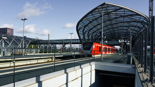 Free Elbbrücken station in Hamburg with a train arriving under its modern glass roof. Stock Photo