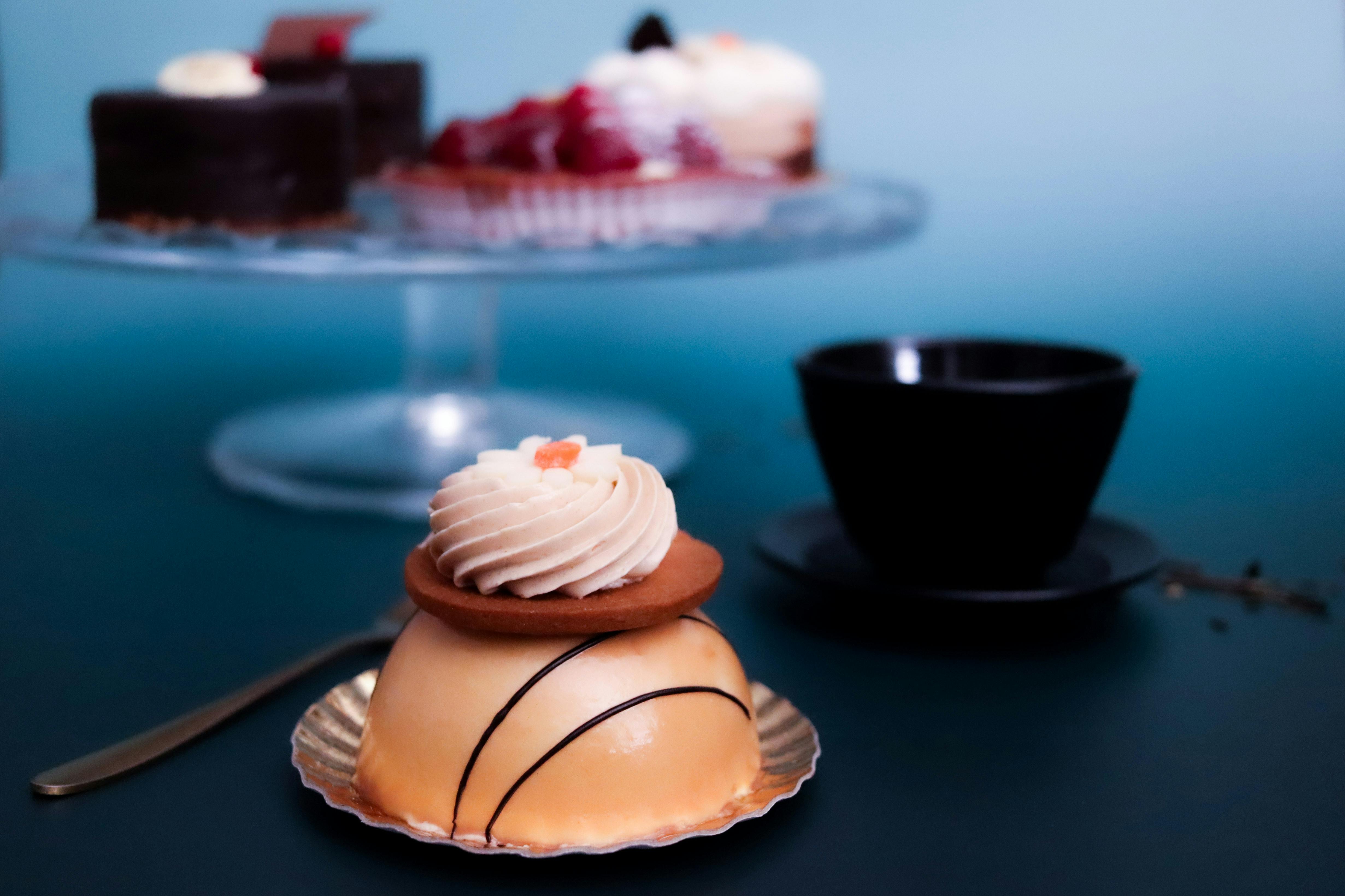 A close-up of a beautifully crafted French pastry with cream set against a stylish backdrop, perfect for dessert inspirations.