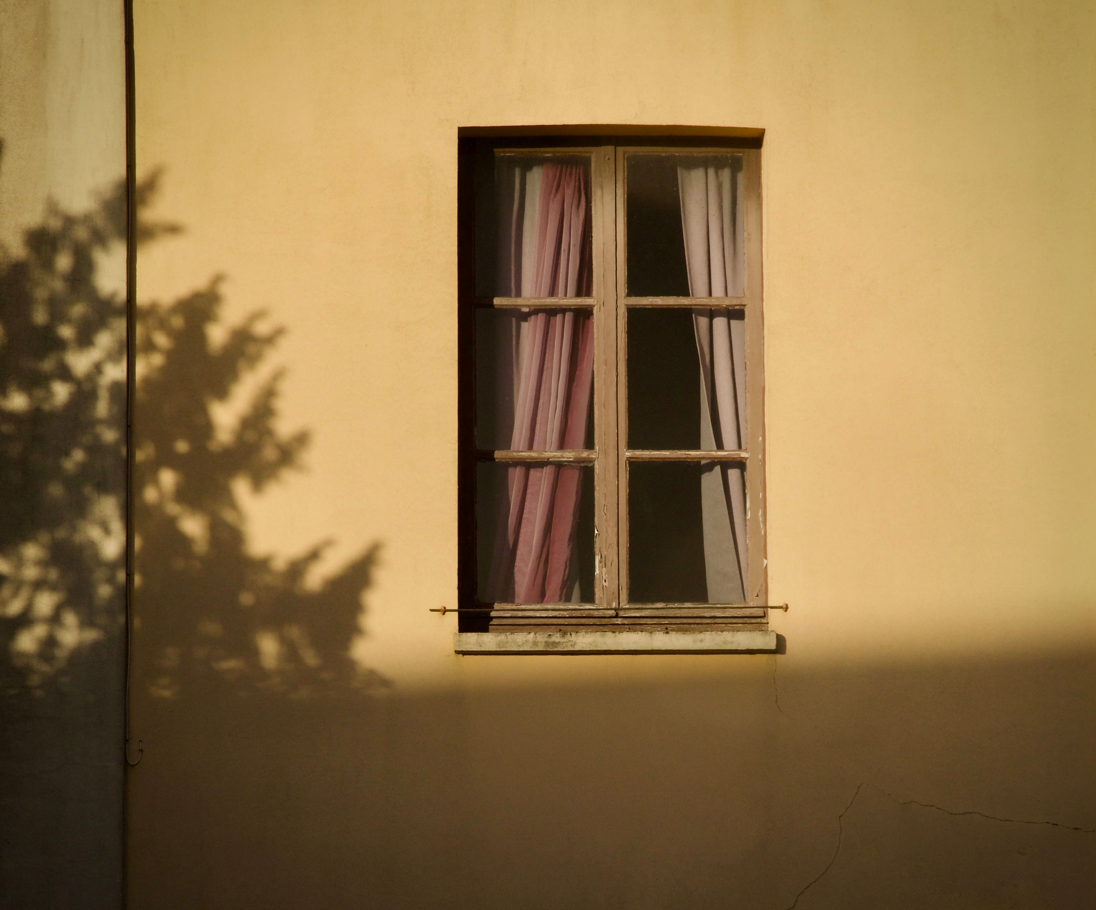 Shadowed Window with Drapes in Golden Light · Free Stock Photo