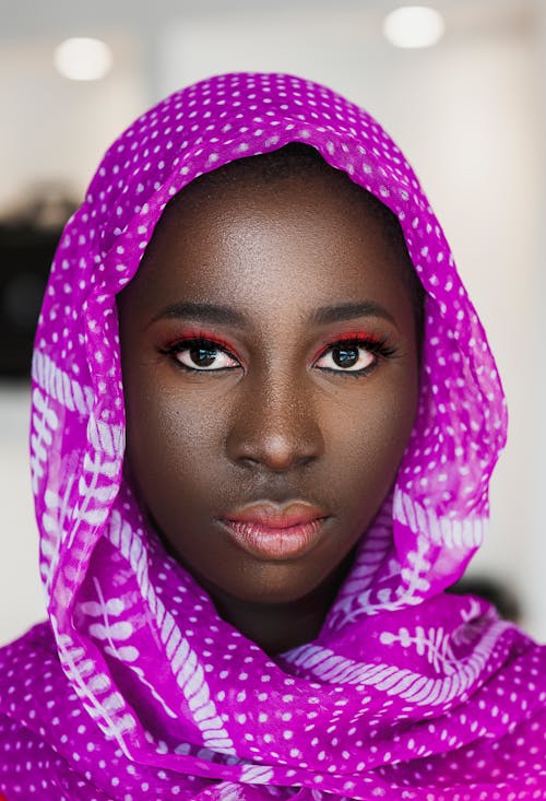 Woman Wearing a Purple Headscarf Staring
