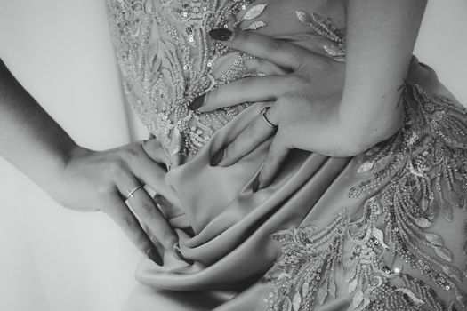 Close-up of elegant evening wear with lace detail in black and white.