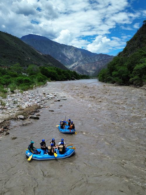 Free Group enjoying thrilling river rafting through scenic mountainous landscape. Stock Photo
