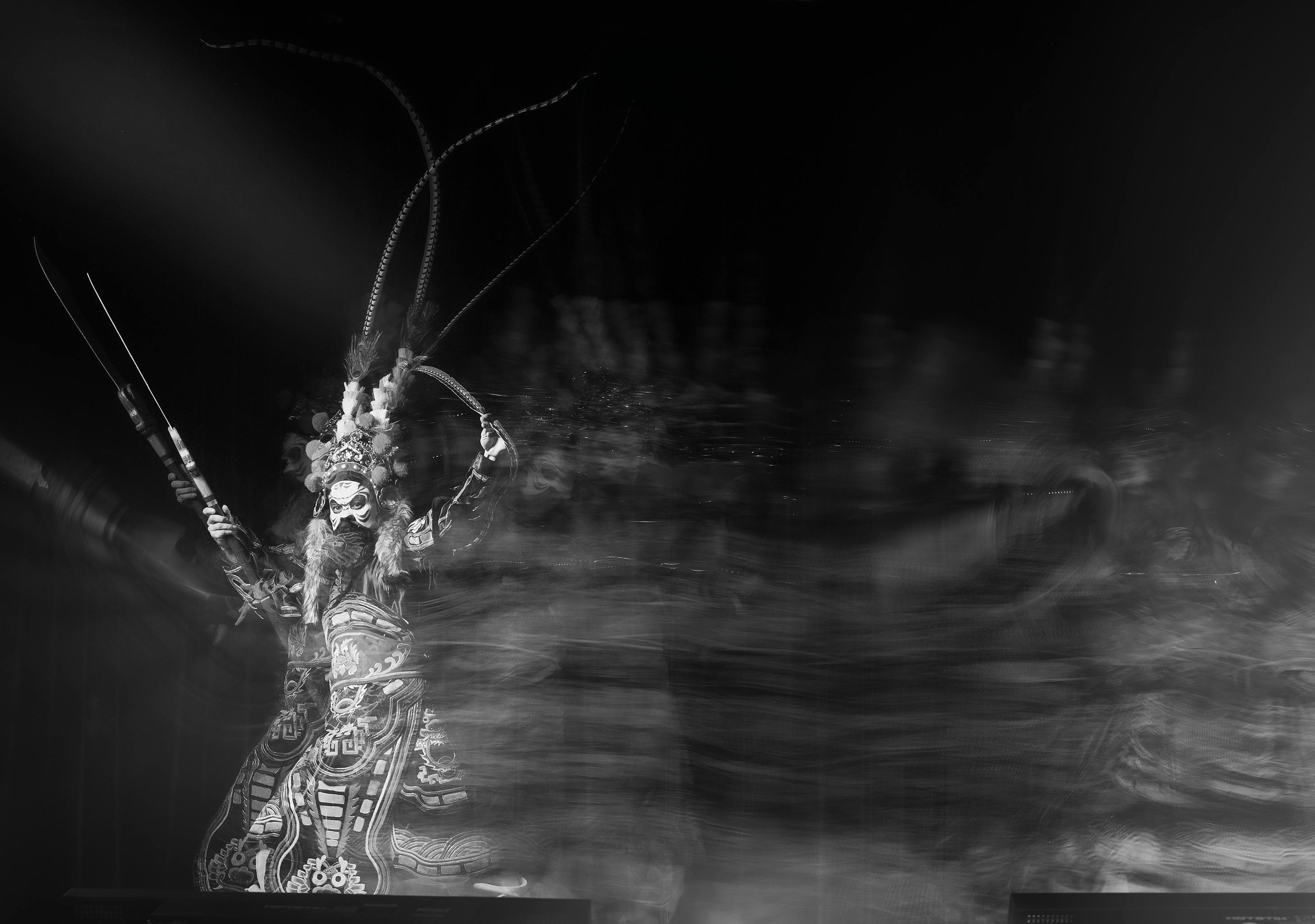 Free Black and white image of a traditional performer in dynamic motion blur. Stock Photo